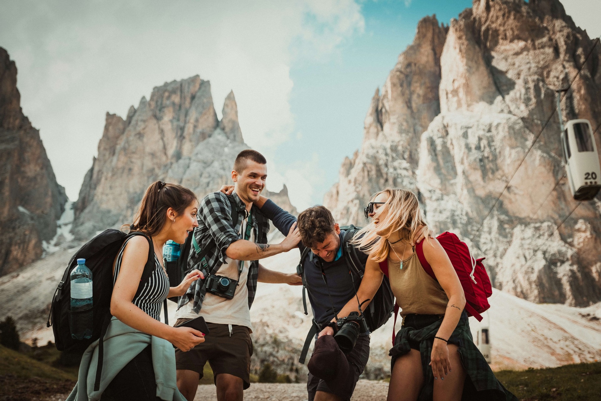 Friends laughing together while traveling through the European mountains